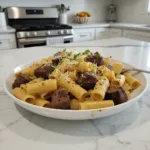 cajun steak tips in cheesy rigatoni parmesan sauce featured 1